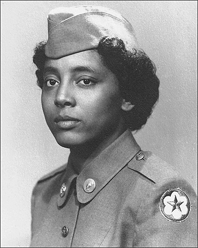 A woman in military uniform facing left with head forward